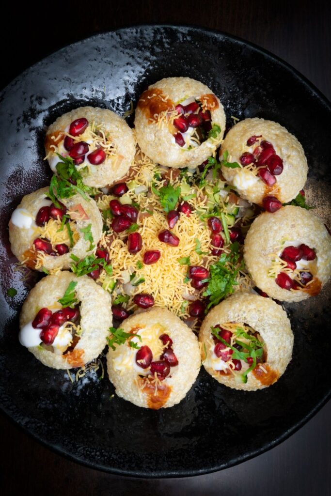 Crispy Sev Puri chaat topped with noodles and chutneys