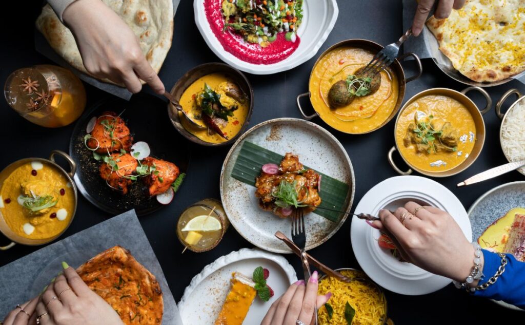 Sula Commercial Drive: Authentic Indian Cuisine Spread Assortment of vibrant Indian dishes served at Sula Indian Restaurant on Commercial Drive, Vancouver.