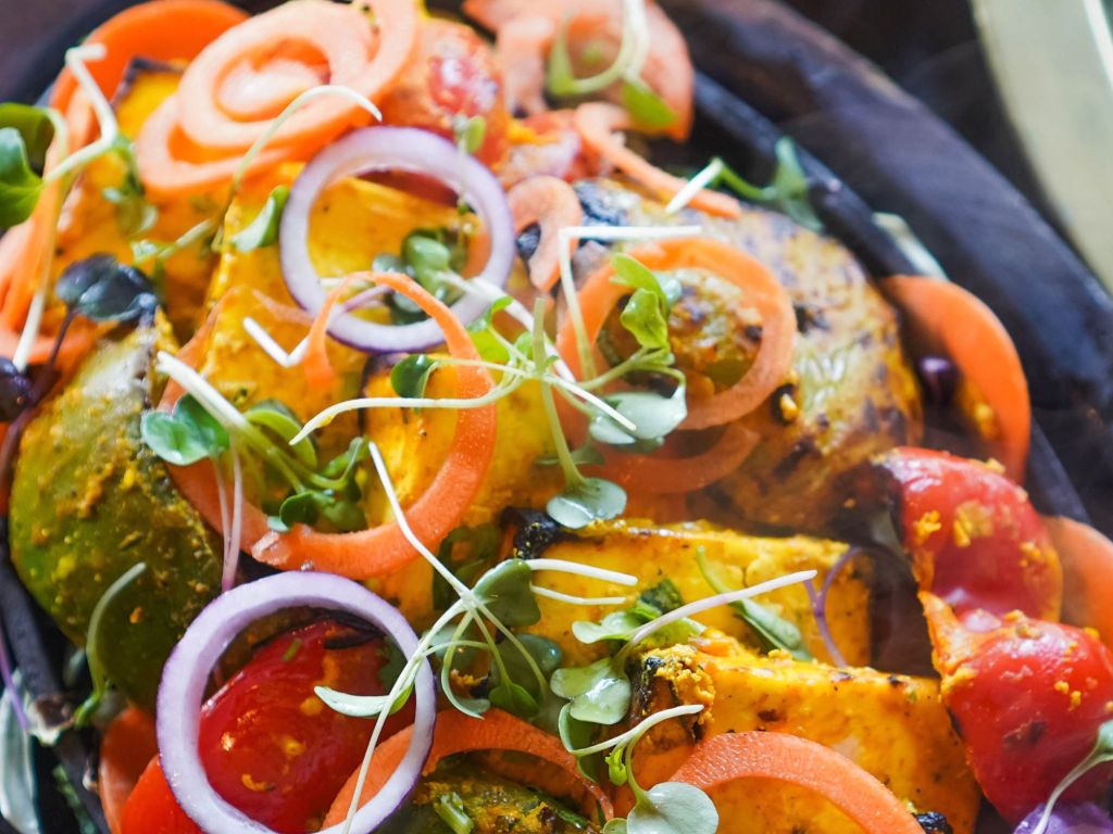 Smoky grilled paneer tikka skewers with vegetables.