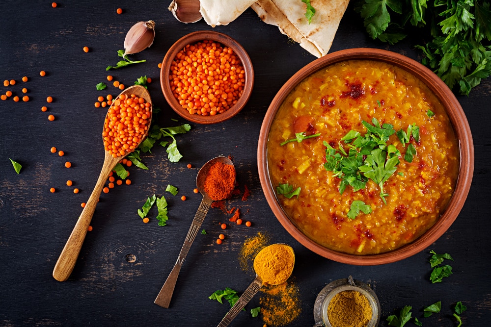 Simple Three Recipes To Learn - Basics Of Indian Cooking traditional indian soup lentils indian dhal spicy curry bowl spices herbs rustic black wooden table 1