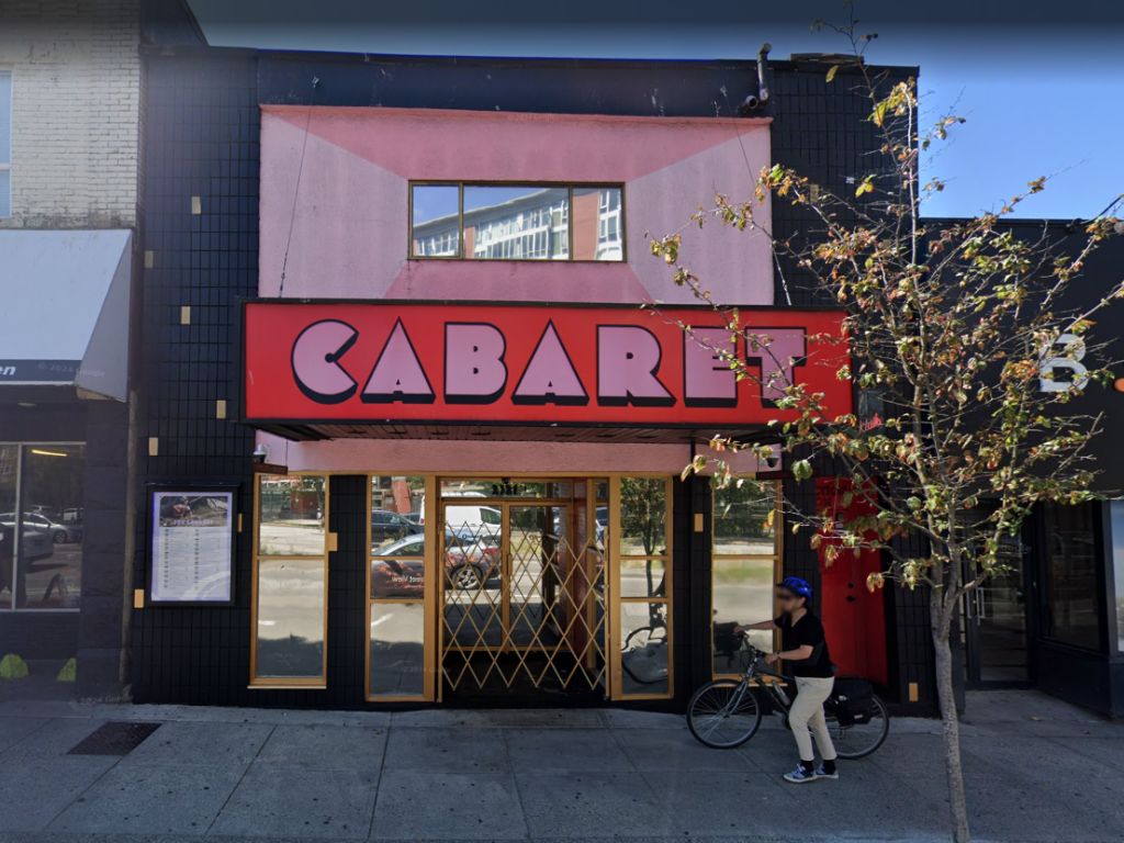 The distinctive neon-lit marquee of The Fox Cabaret, announcing upcoming shows and events against a nighttime or dusk sky.