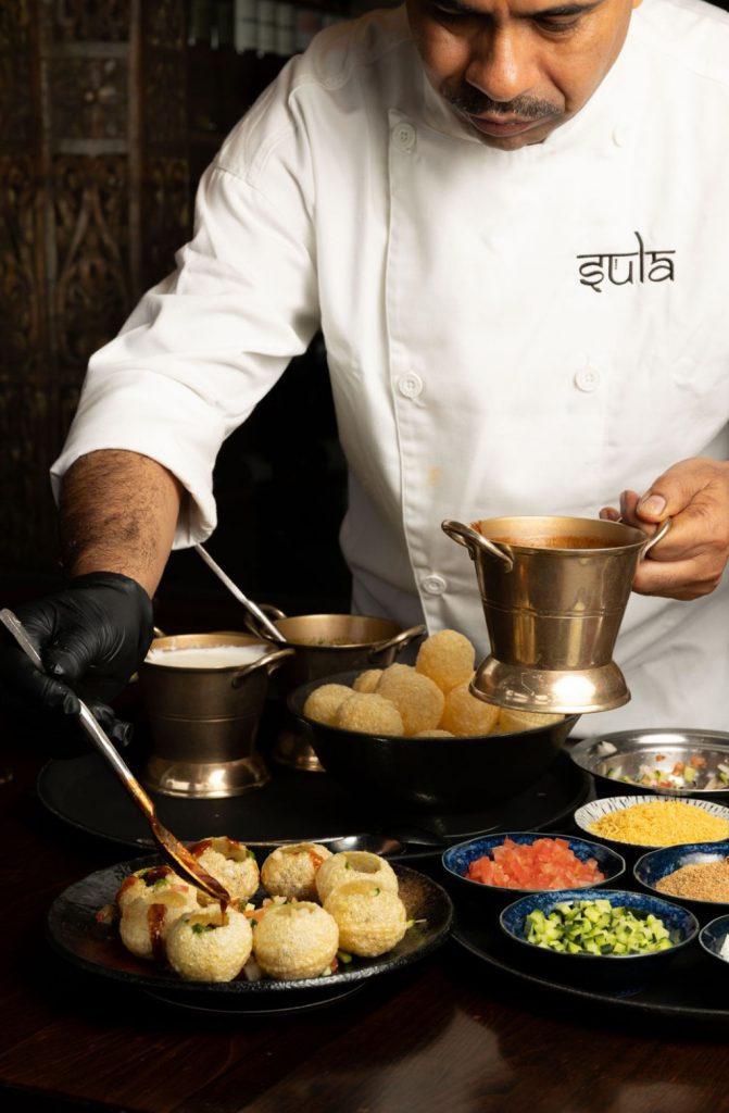 chef making dishes at an indian restaruant in Vancouver