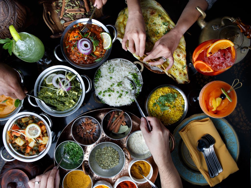 A variety of authentic Indian dishes including curries breads and rice