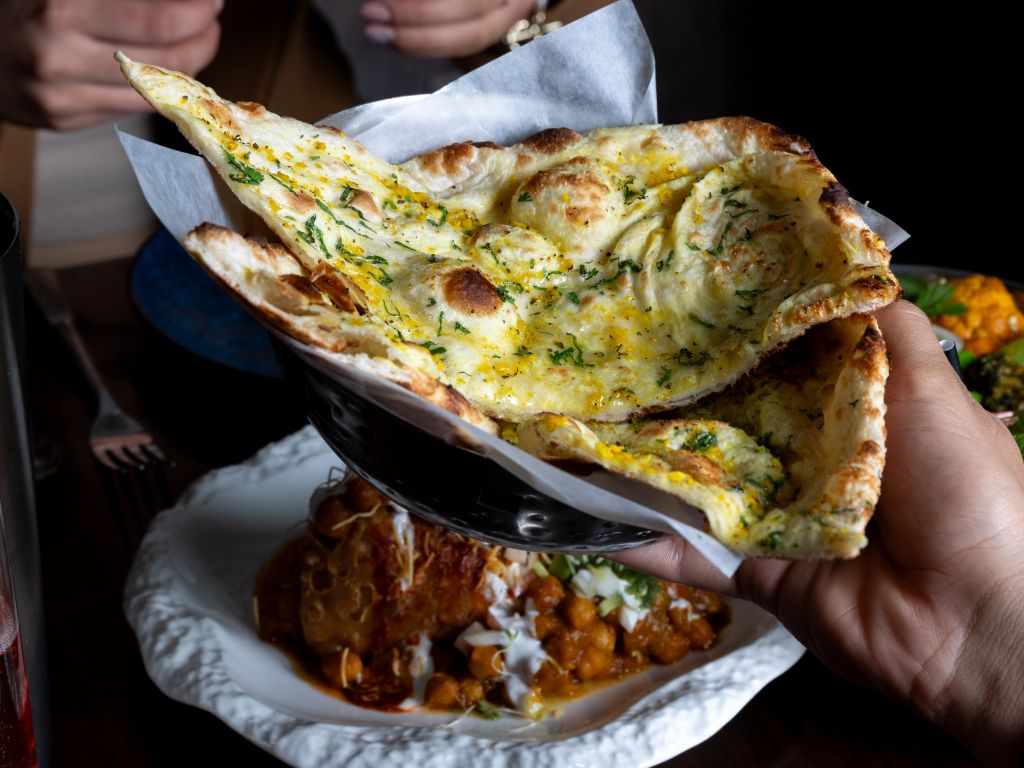 Fluffy garlic naan brushed with butter served hot at Sula Indian Restaurant