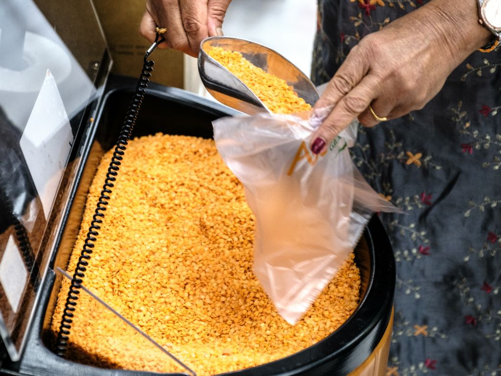 Two bins filled with lentils and seeds at a market near Sula